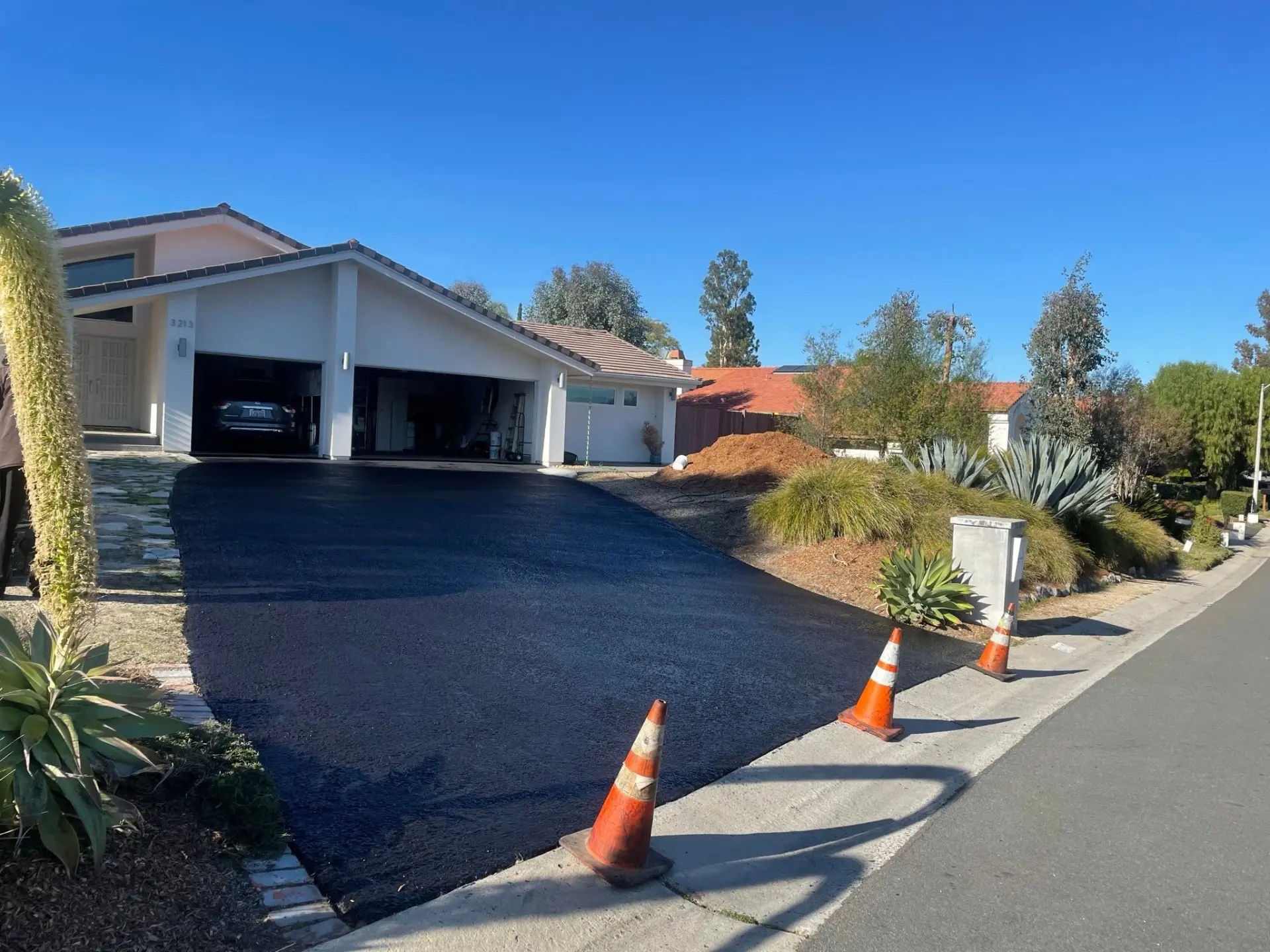 Freshly paved residential asphalt driveway by Supreme Paving Co in Murrieta, CA