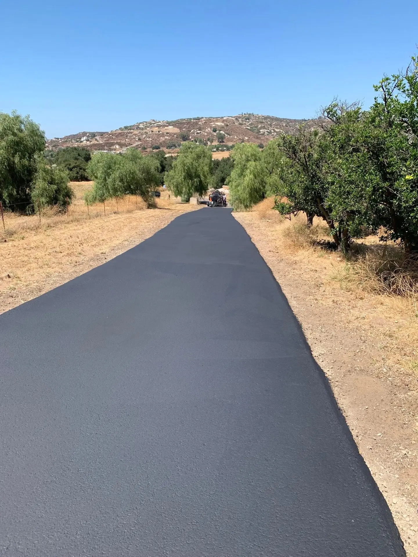 Long freshly paved private access road in Murrieta, California